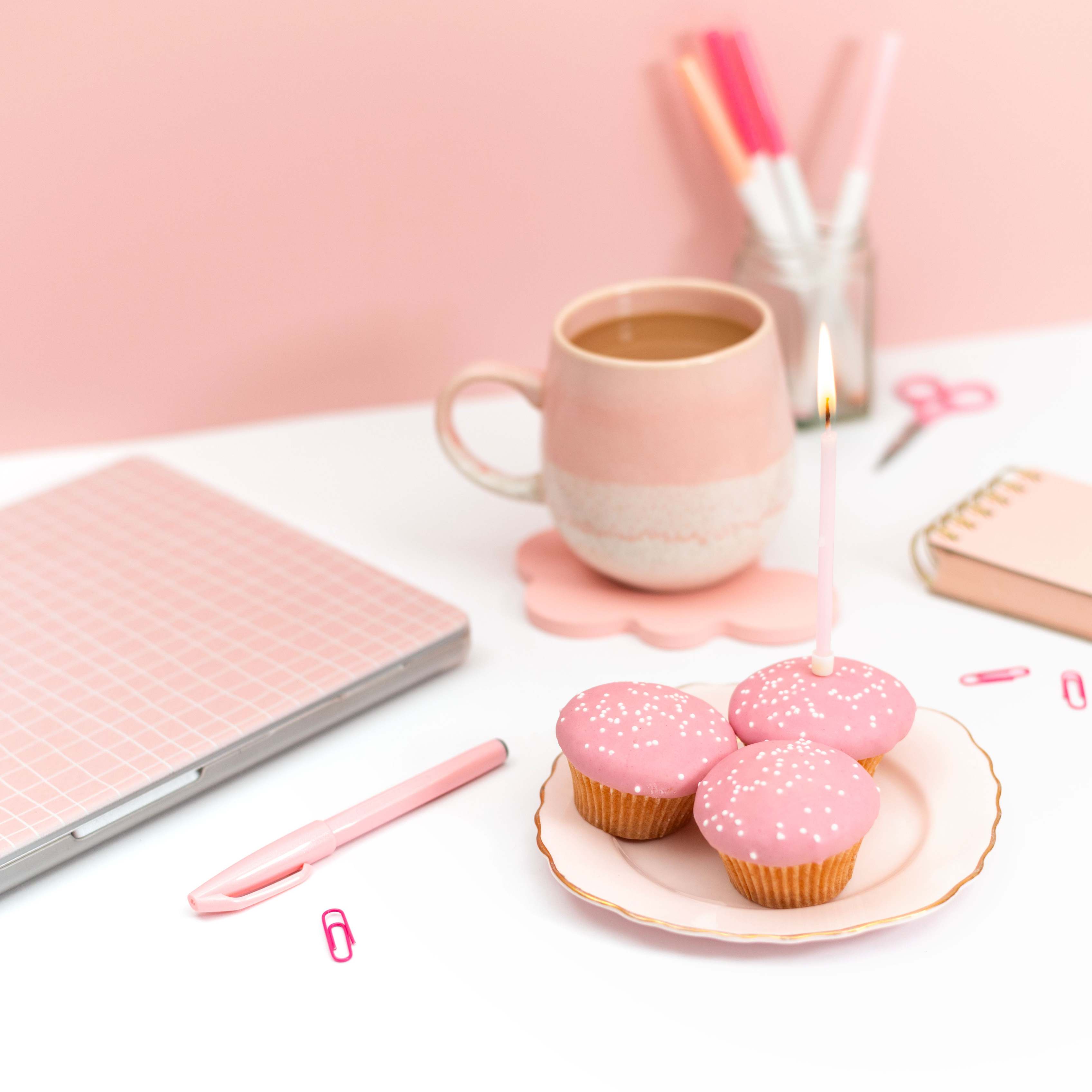 Desk flat lay with laptop, keyboard, and coffee mug
