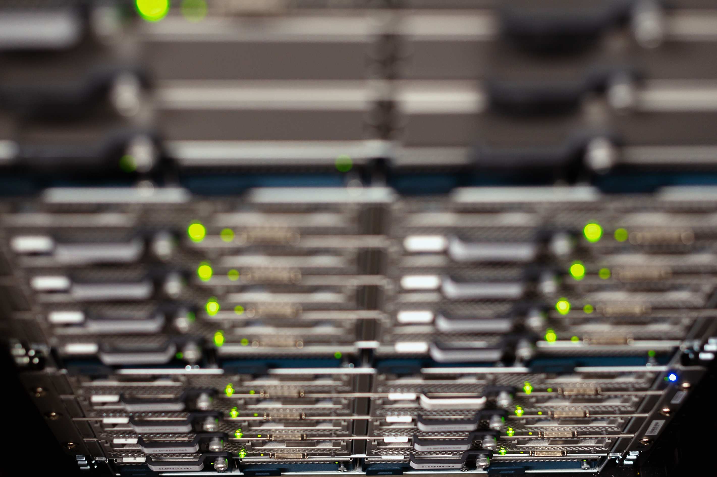 Server racks in a data hall with contemporary server cable trays