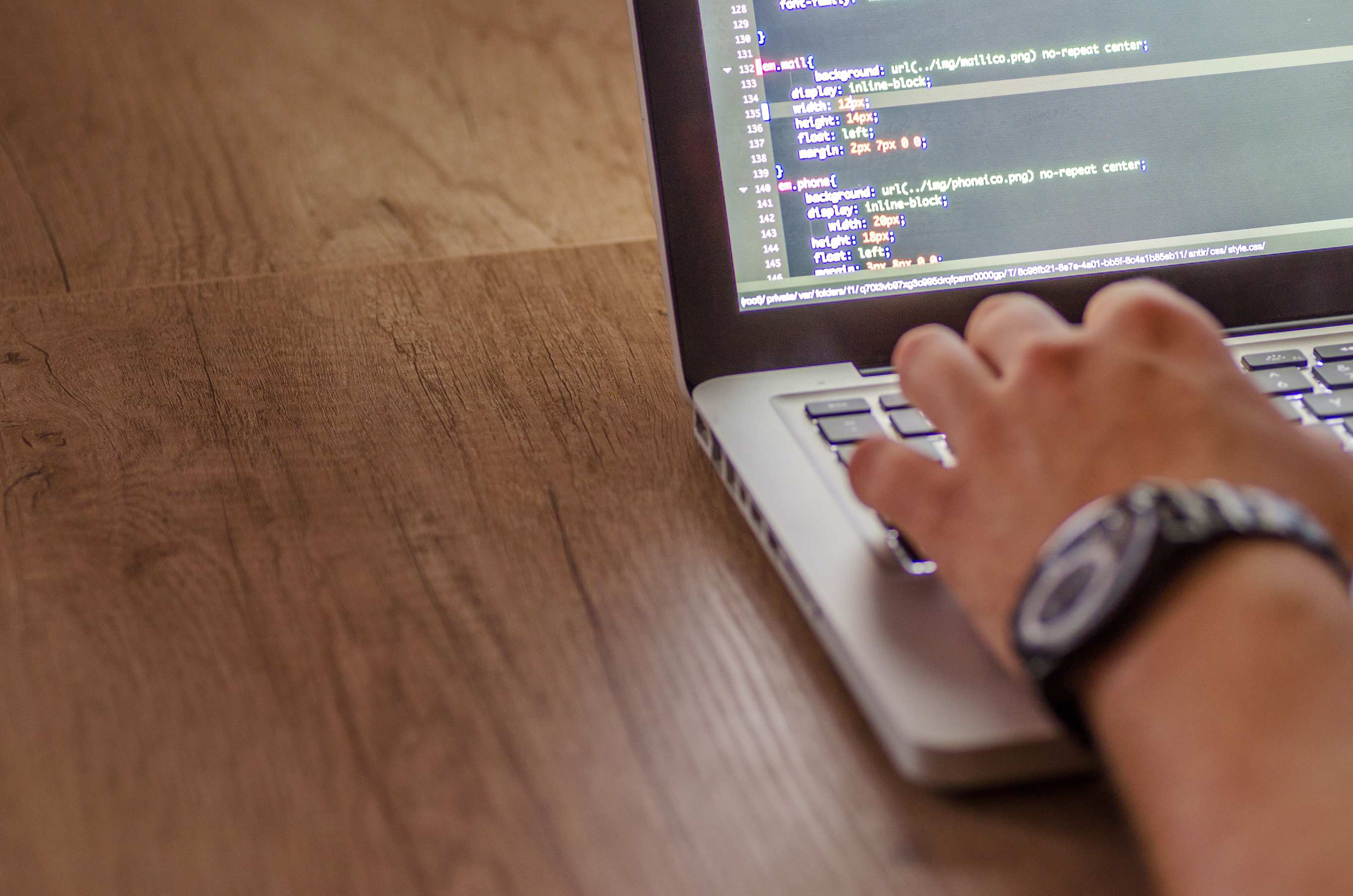 Person coding on a laptop during a programming session